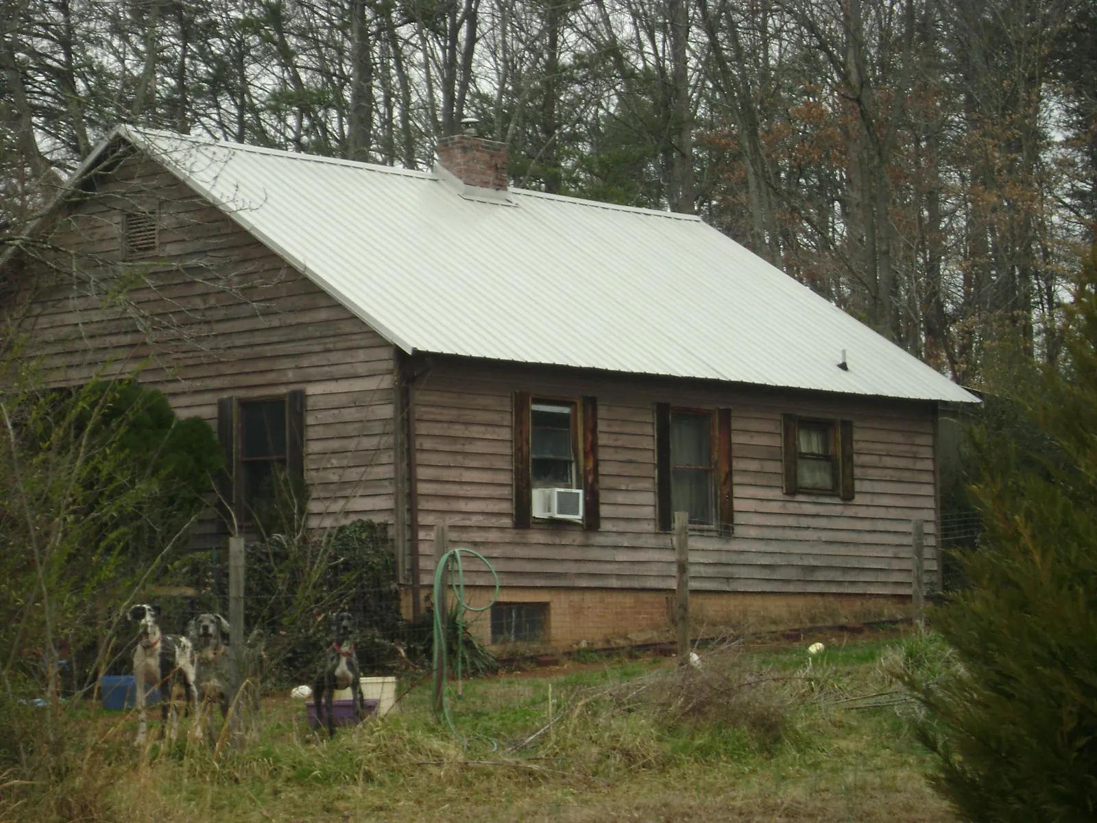 White metal roof on an old wood sided farmhouse, from a Metal Roof Installation job in Mount Gilead